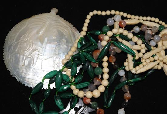 An agate bead necklace, a malachite necklace an ivory necklace a carved shell and pique cross brooch (a.f.).